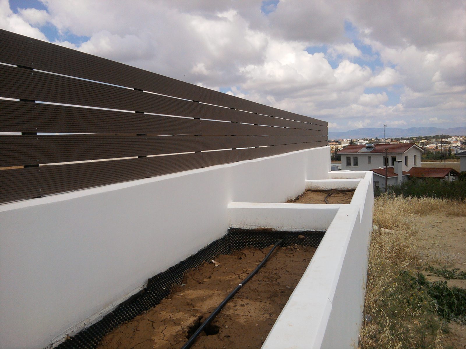 Slat infill above a rendered boundary wall