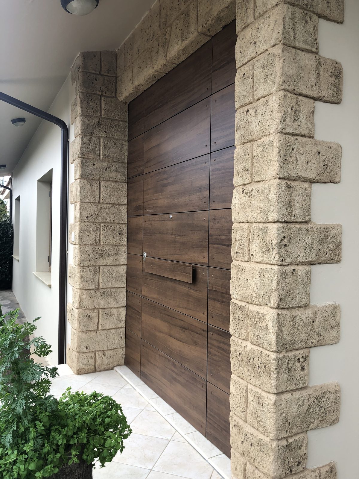 Timber gate recessed into stonework