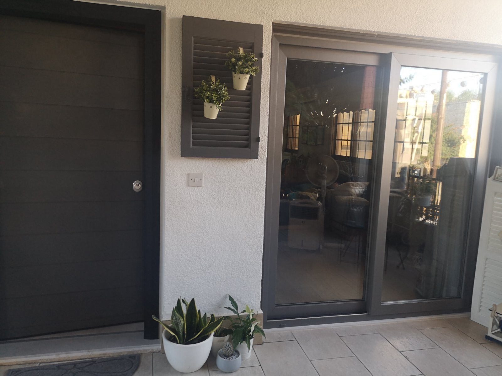 Dark aluminium sliding doors opening to a garden